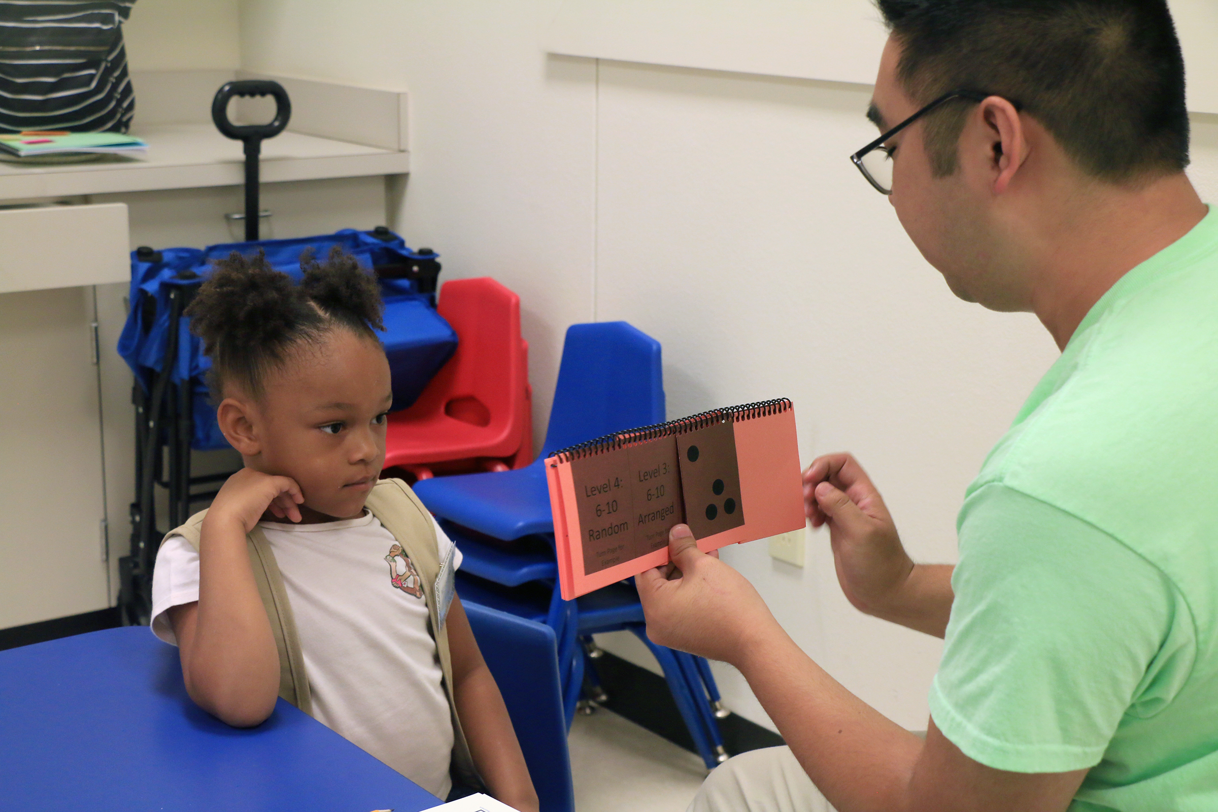 Student learning math with Baylor student at Baylor Math for Early Learners Academy