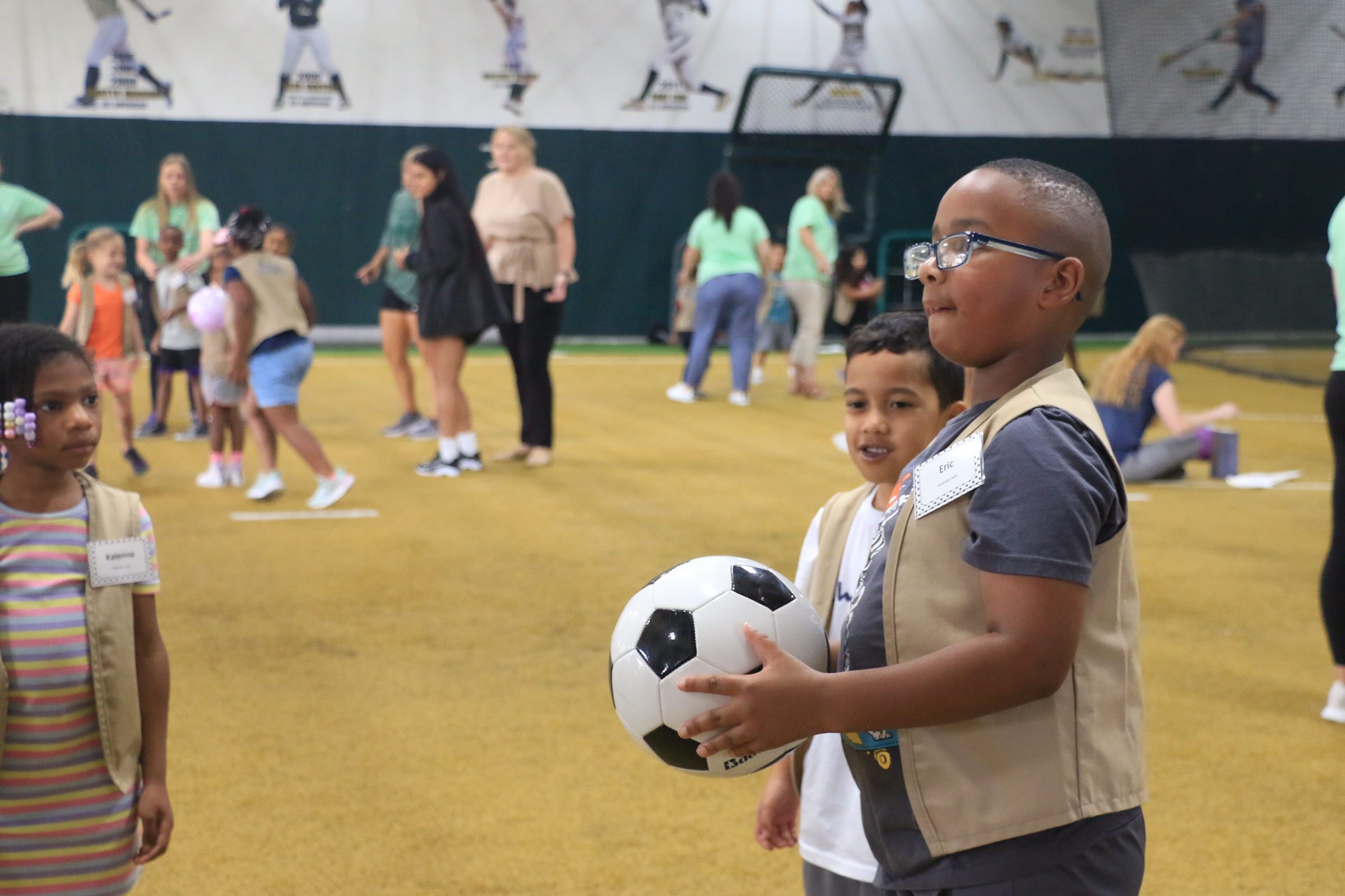 Students playing with Baylor athletes at Baylor Math for Early Learners Academy