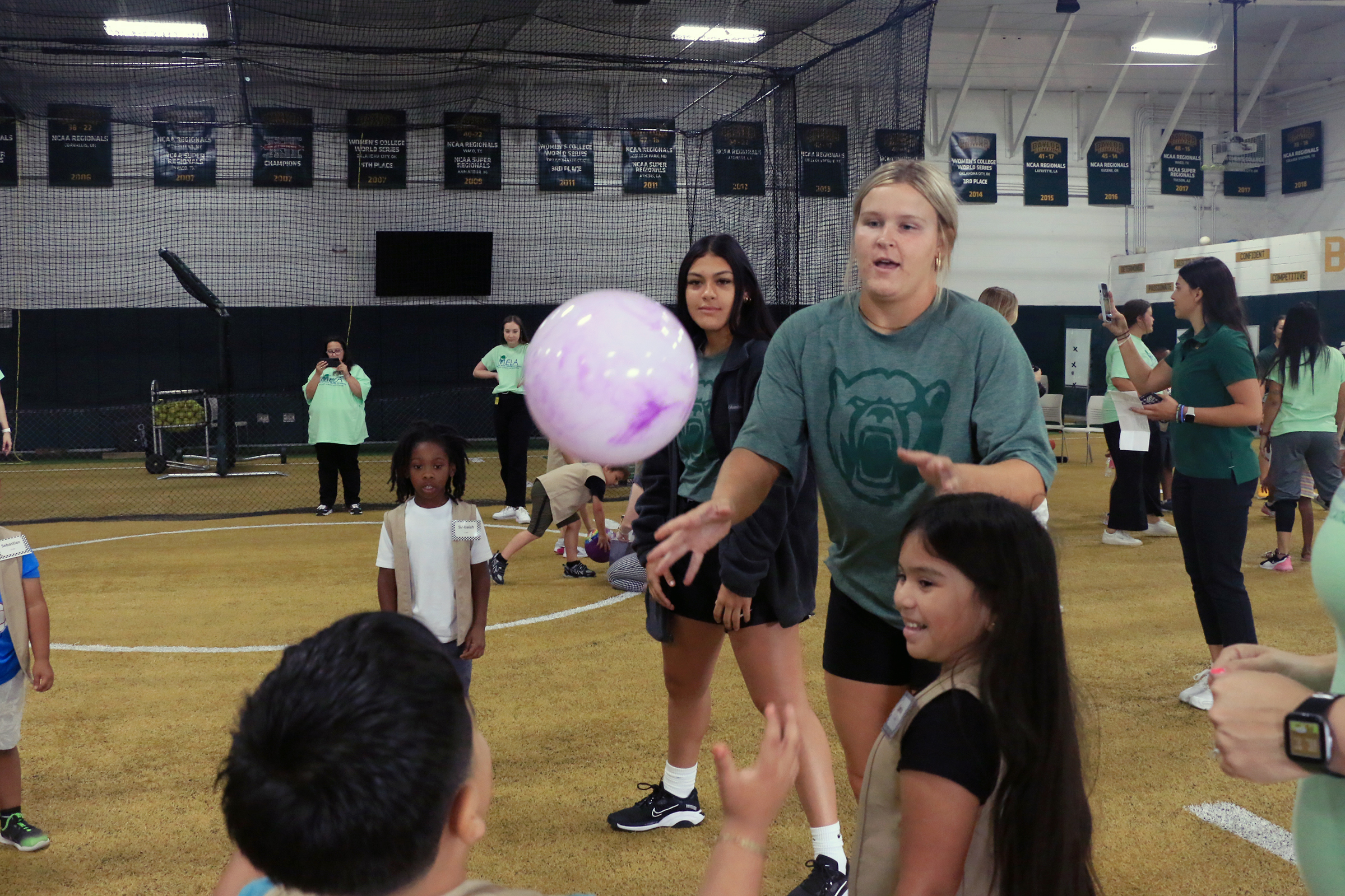 Students playing with Baylor athletes at Baylor Math for Early Learners Academy