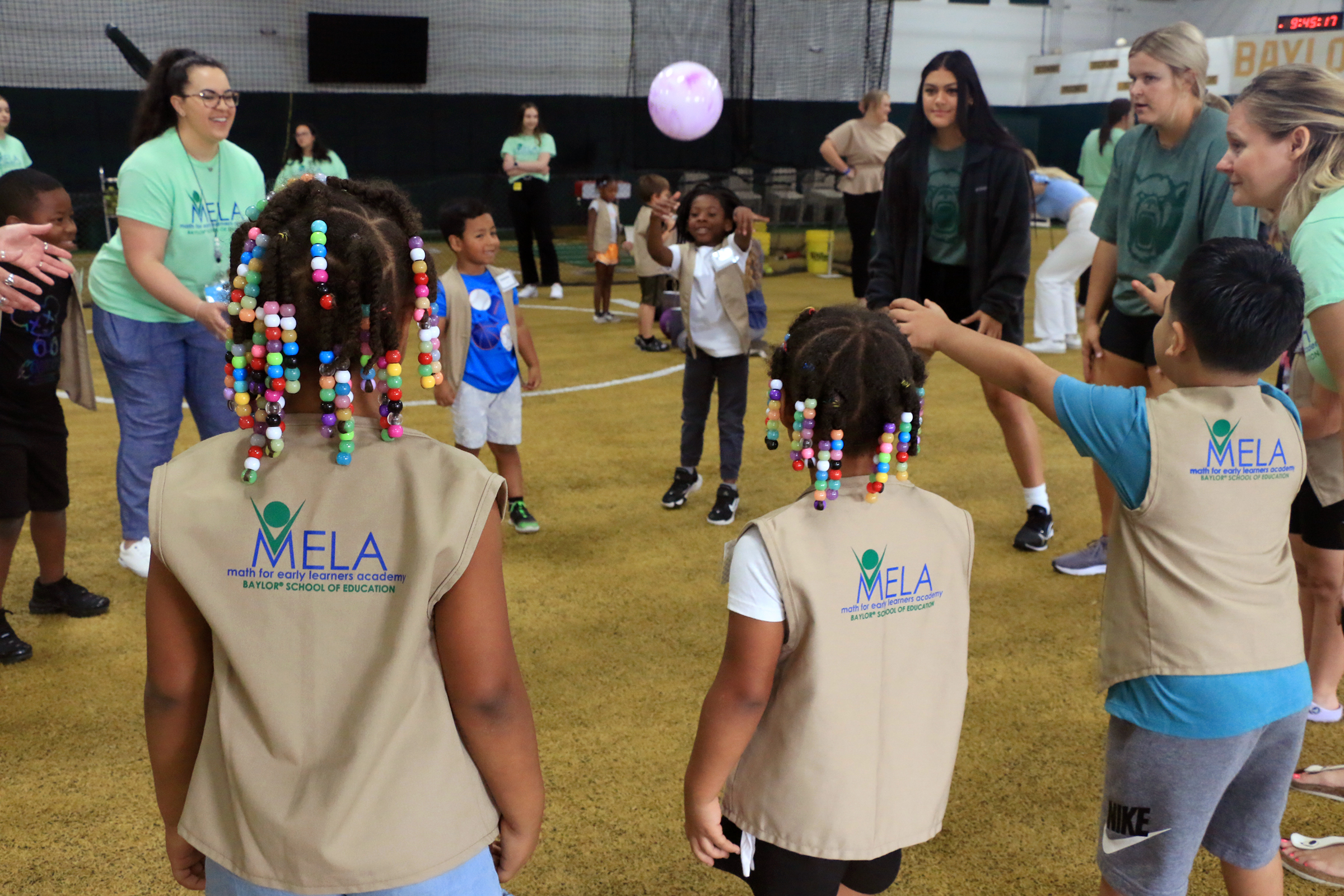 Students playing with Baylor athletes at Baylor Math for Early Learners Academy