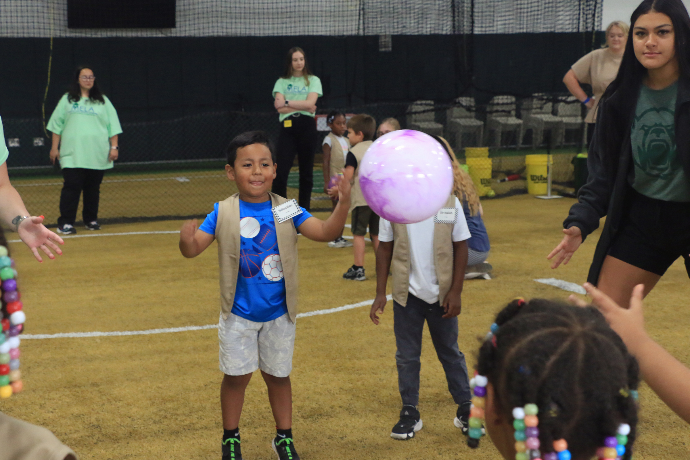 Students playing with Baylor athletes at Baylor Math for Early Learners Academy