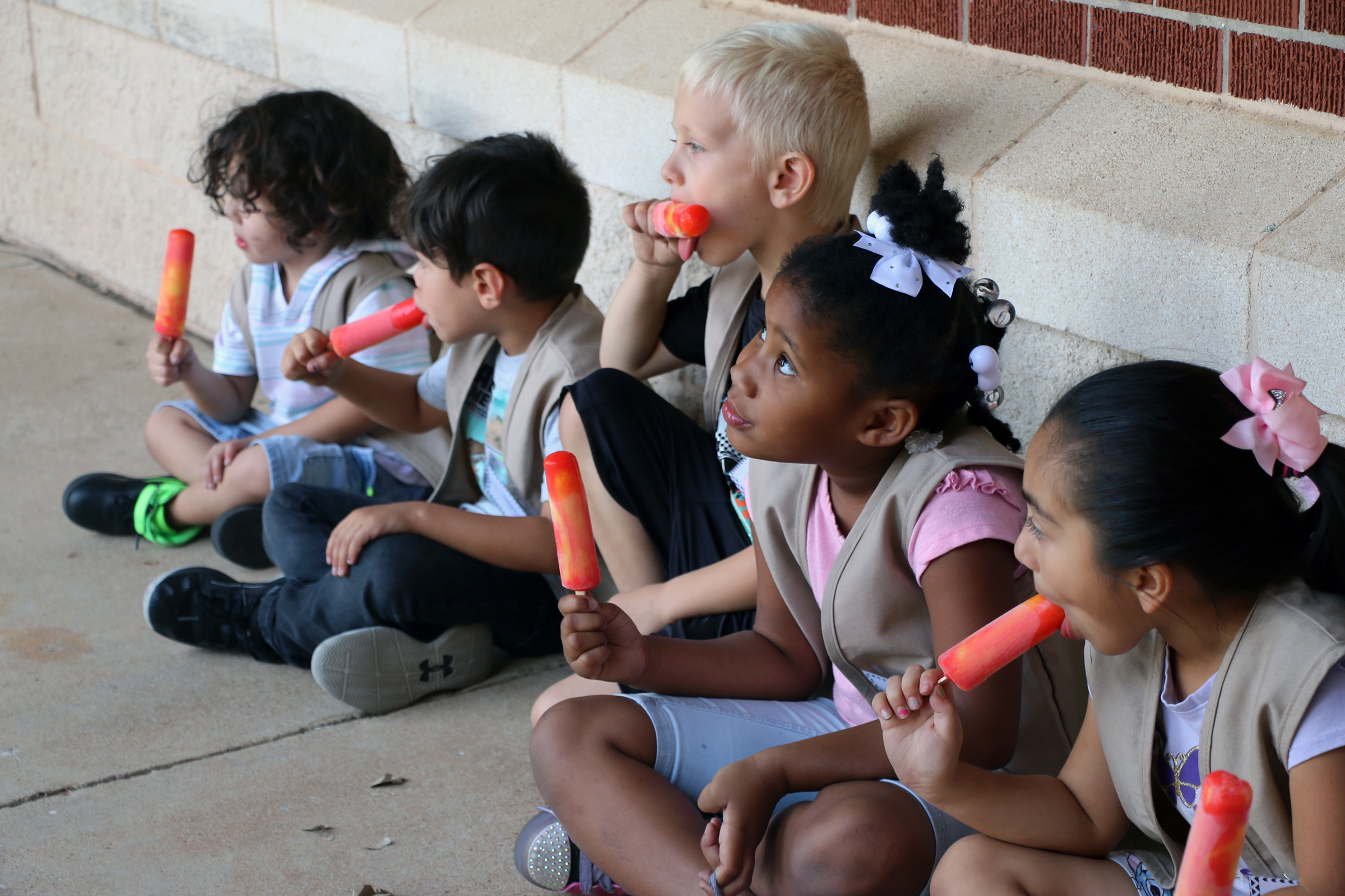 Students enjoying popsicles after playing with Baylor athletes at Baylor Math for Early Learners Academy