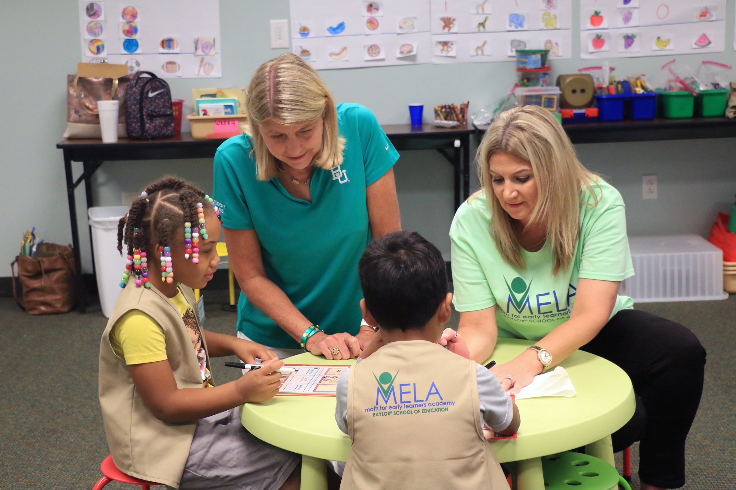 Student learning math with Baylor President Dr. Linda Livingstone at Baylor Math for Early Learners Academy