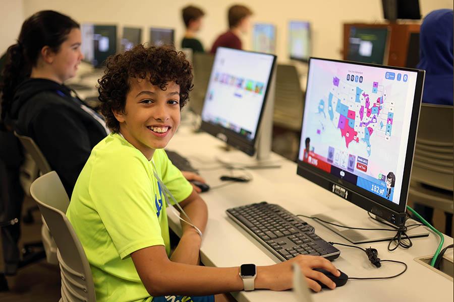 Middle schooler at iEngage Civics camp playing computer games from iCivics